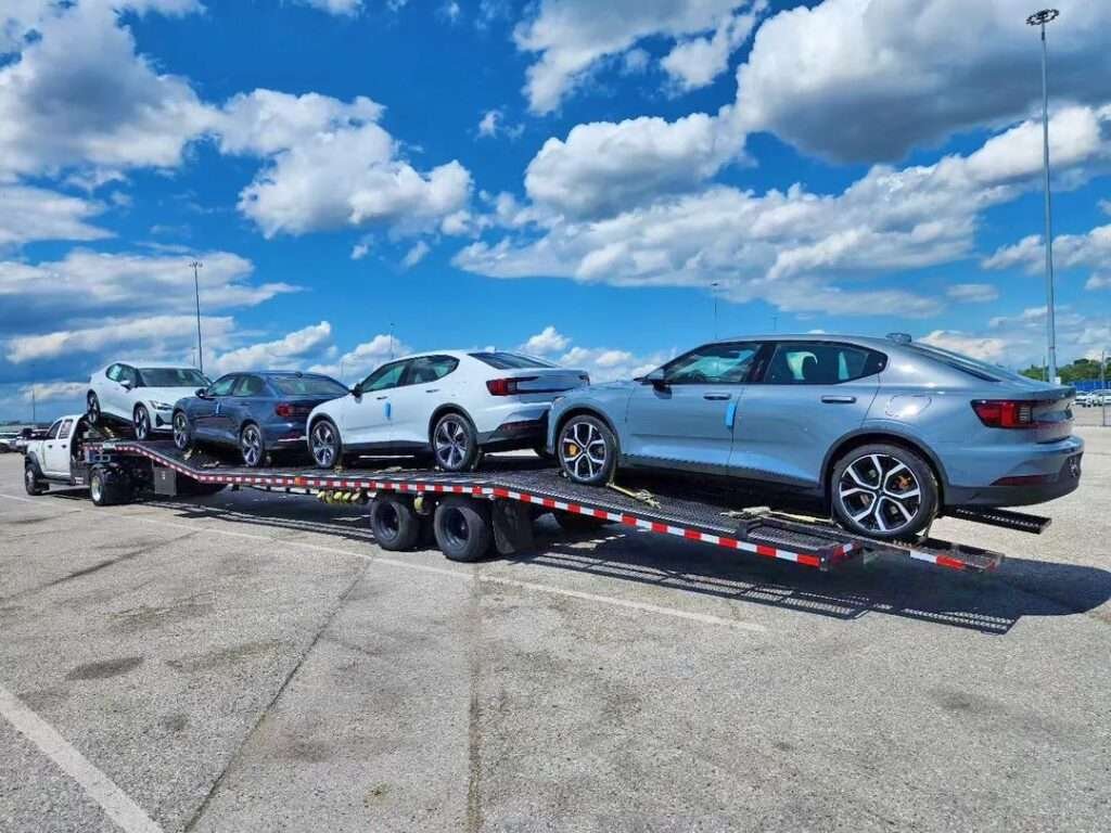 cars being transport on open carrier trailer